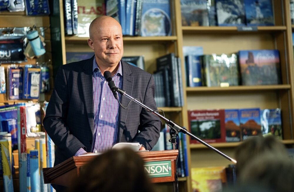 John Gormley speaking into a microphone at a bookstore event